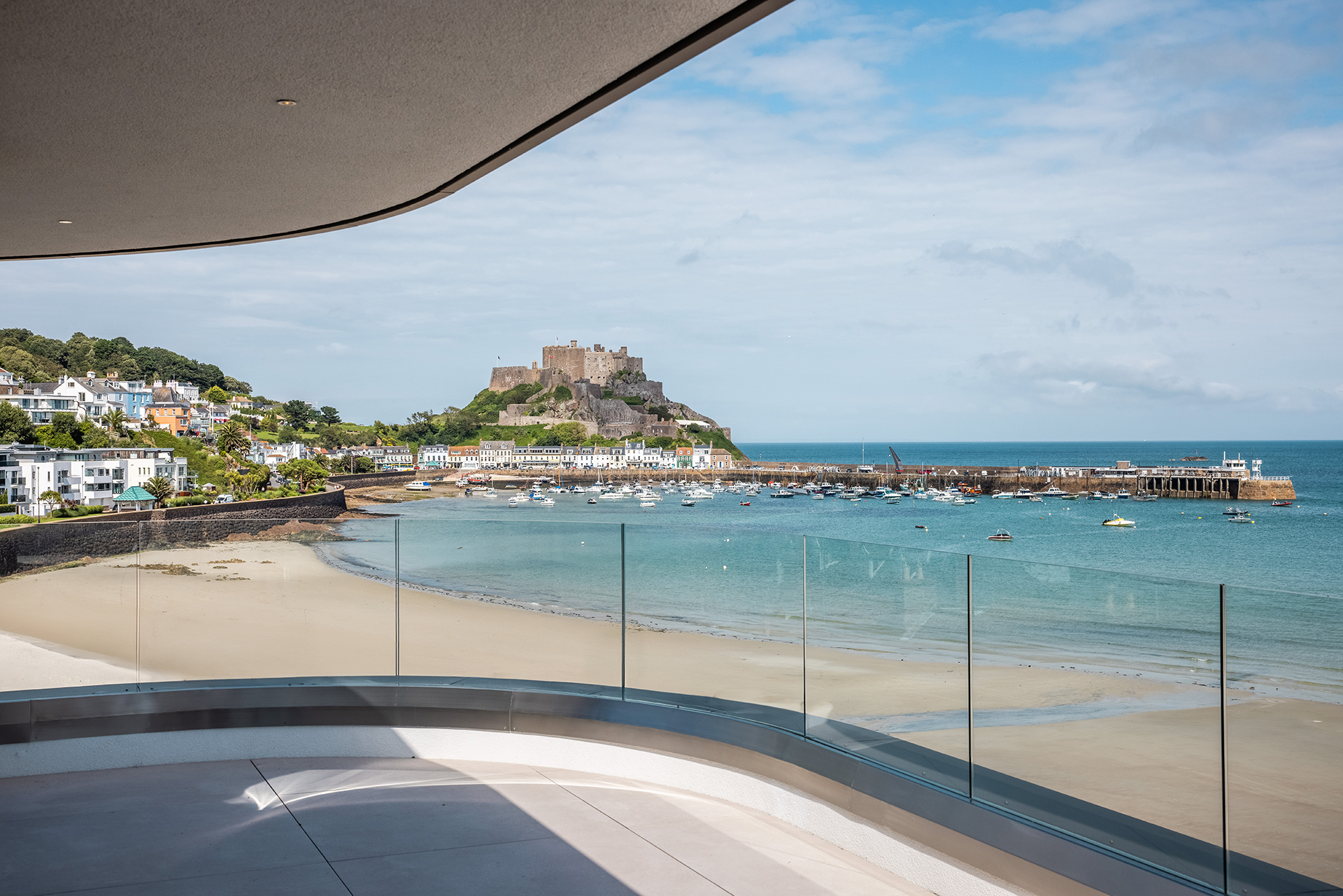 View from a balcony overlooking Gorey castle, the sea and the pier in Jersey