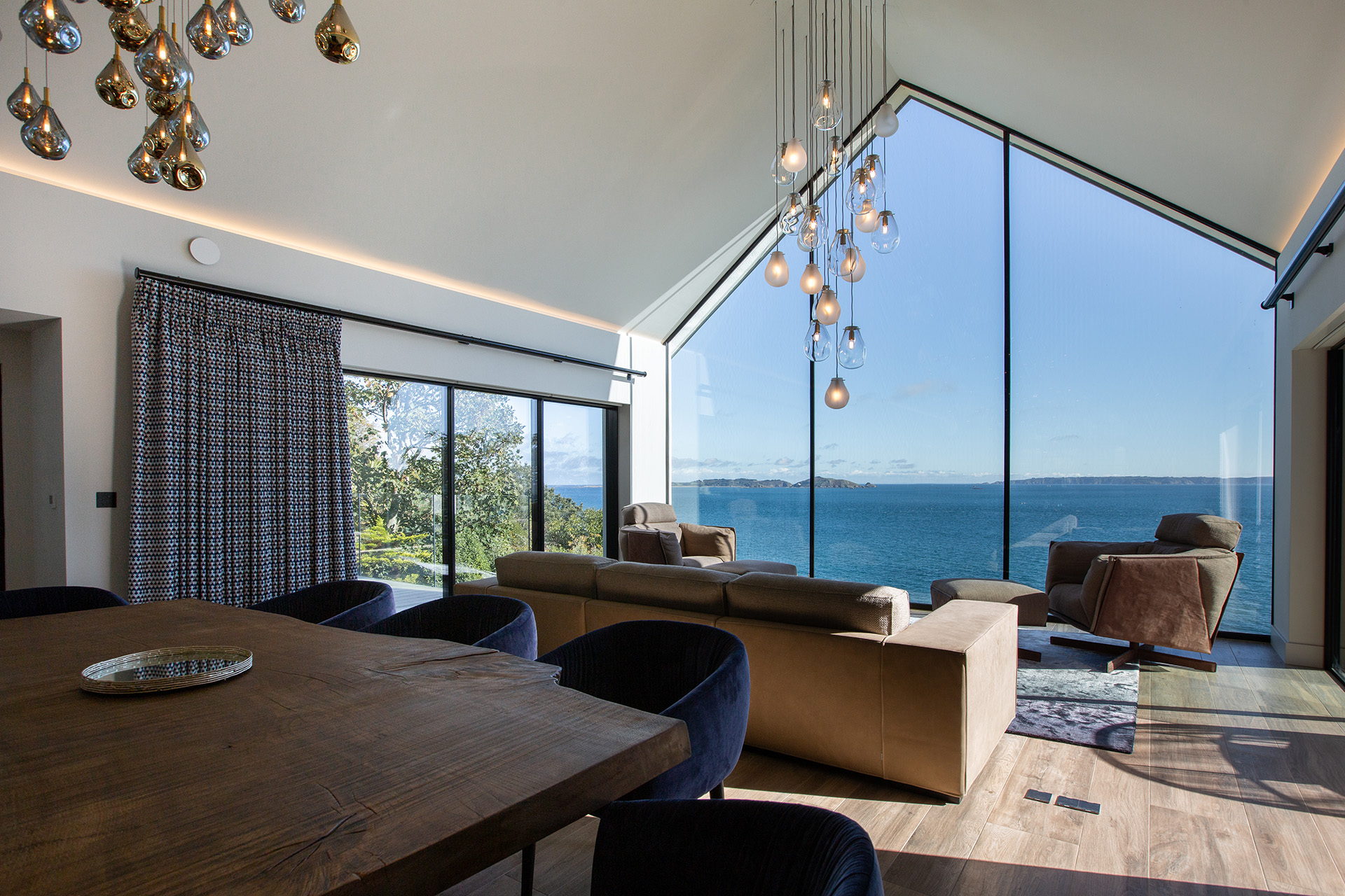 Interior shot of a modern house in Fort George with a large window overlooking the sea