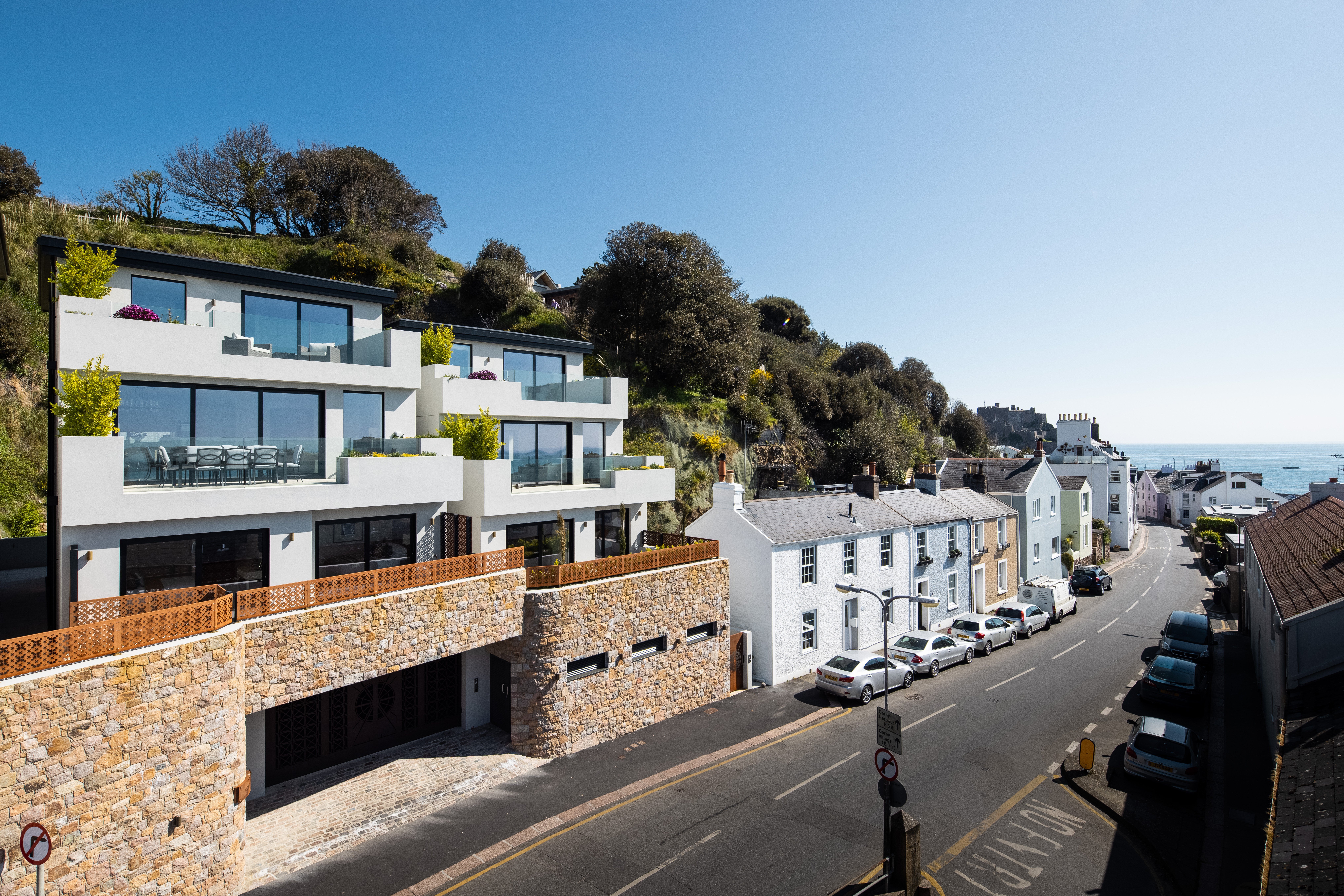 Houses along Le Mont Gabard in Jersey, showcasing a variety of architectural style, including one modern among more tradtional designs