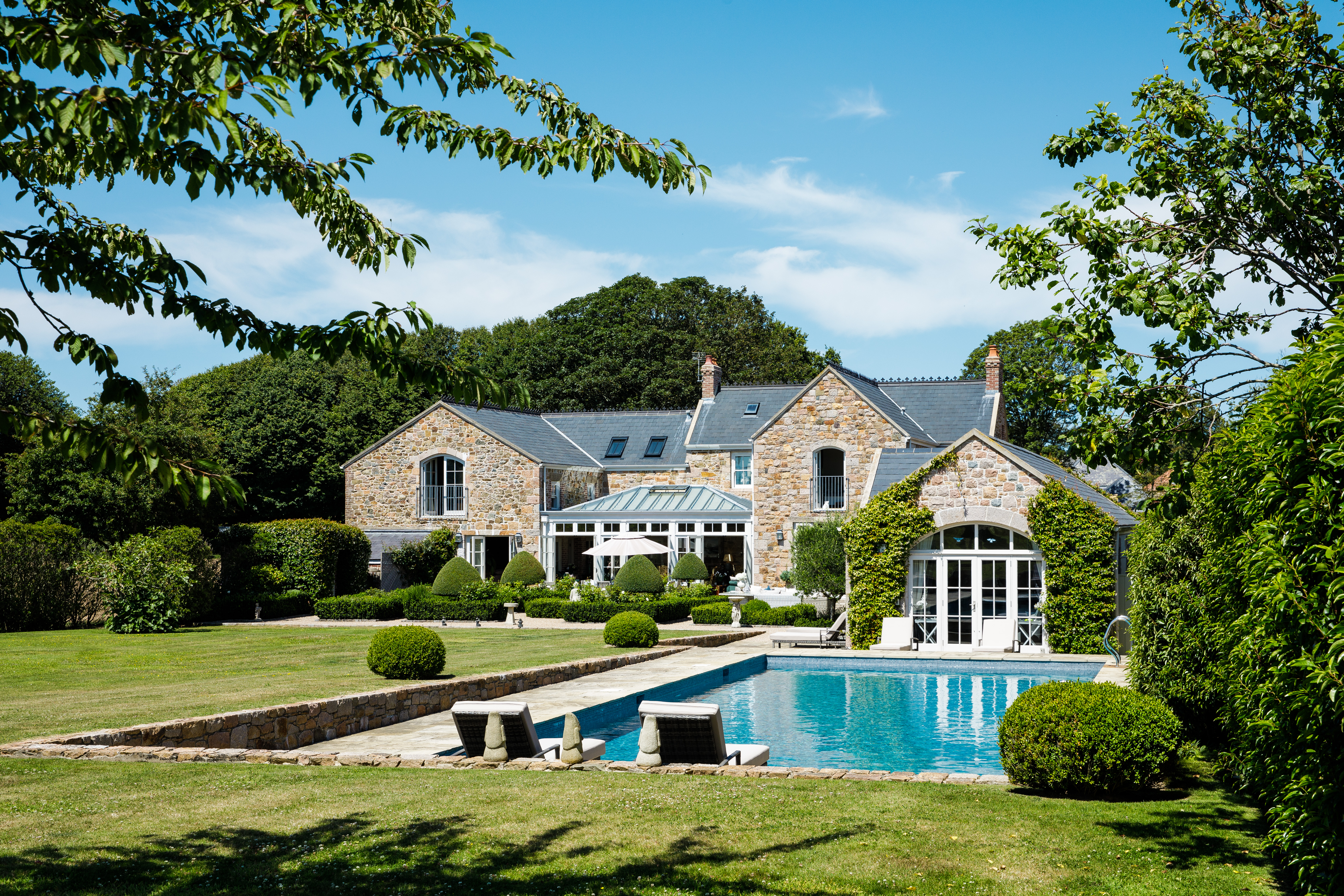 Converted countryside house with a swimming pool, a glass conservatory, and a landscaped garden Jersey