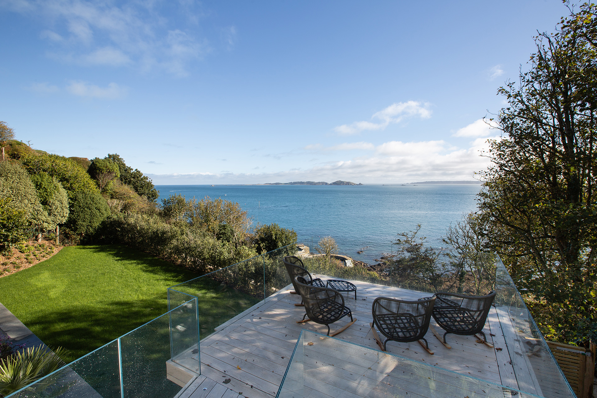 Garden in Guernsey with a patio section and sea view